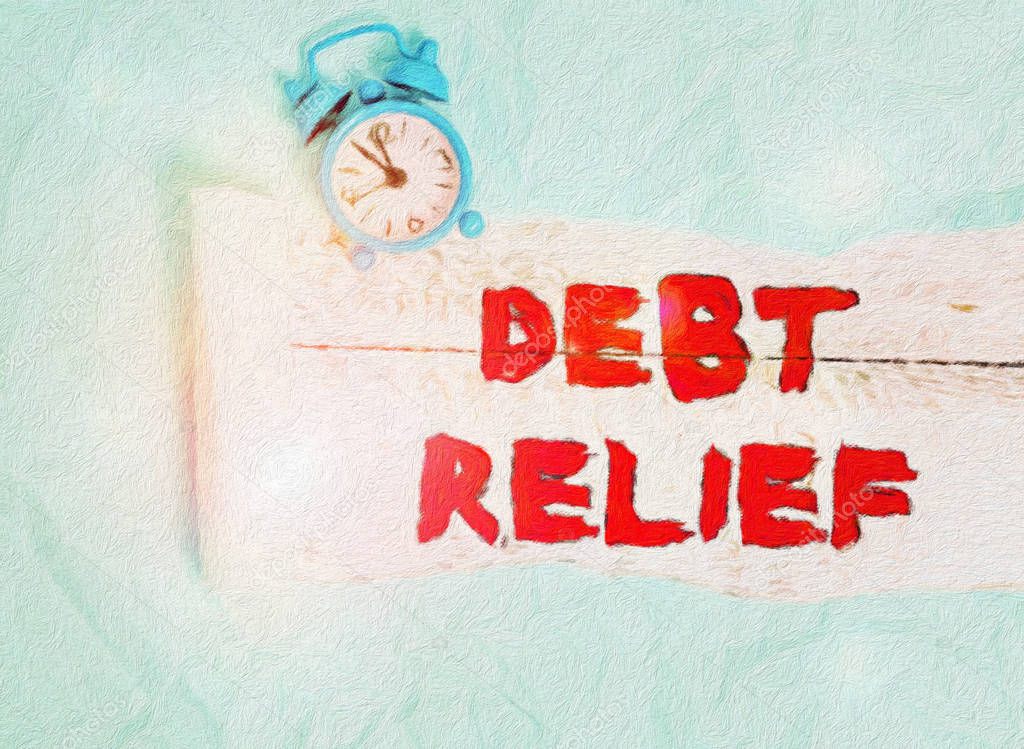 Conceptual hand writing showing Debt Relief. Business photo text a reduction in the amount of debt that a country has to pay Alarm clock and torn cardboard on a wooden classic table backdrop.