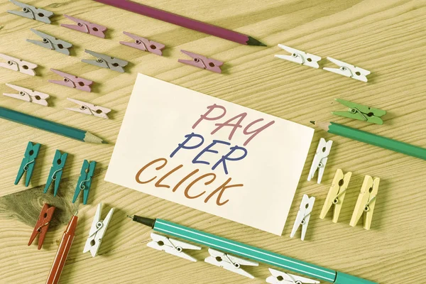 Handwriting text Pay Per Click. Concept meaning Internet Advertising Model Search Engine marketing Strategy Colored clothespin papers empty reminder wooden floor background office. — Stock Photo, Image