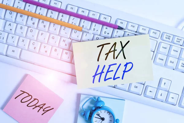 Text sign showing Tax Help. Conceptual photo Assistance from the compulsory contribution to the state revenue Flat lay above empty note paper on the pc keyboard pencils and clock. — Stock Photo, Image