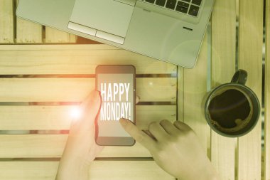 Mutlu Pazartesi 'yi gösteren bir mesaj. Kavramsal fotograf gösteriyor ki, ona harika bir yeni hafta dileği sunan akıllı telefonlu kadın içki kupası ofisi teknolojik cihazlar temin ediyor..