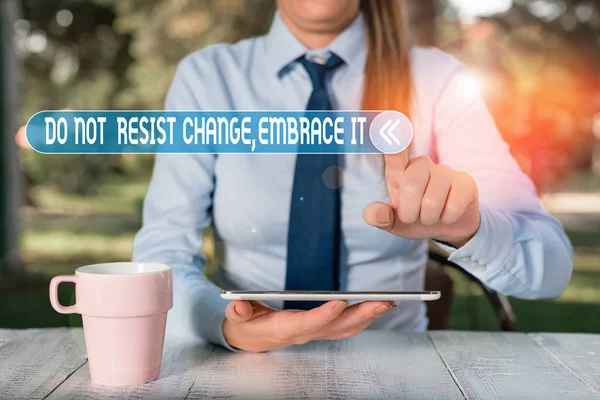 Handwriting text writing Do Not Resist Change Embrace It. Concept meaning Be open to changes try new things Positive Female business person sitting by table and holding mobile phone. — Stok fotoğraf