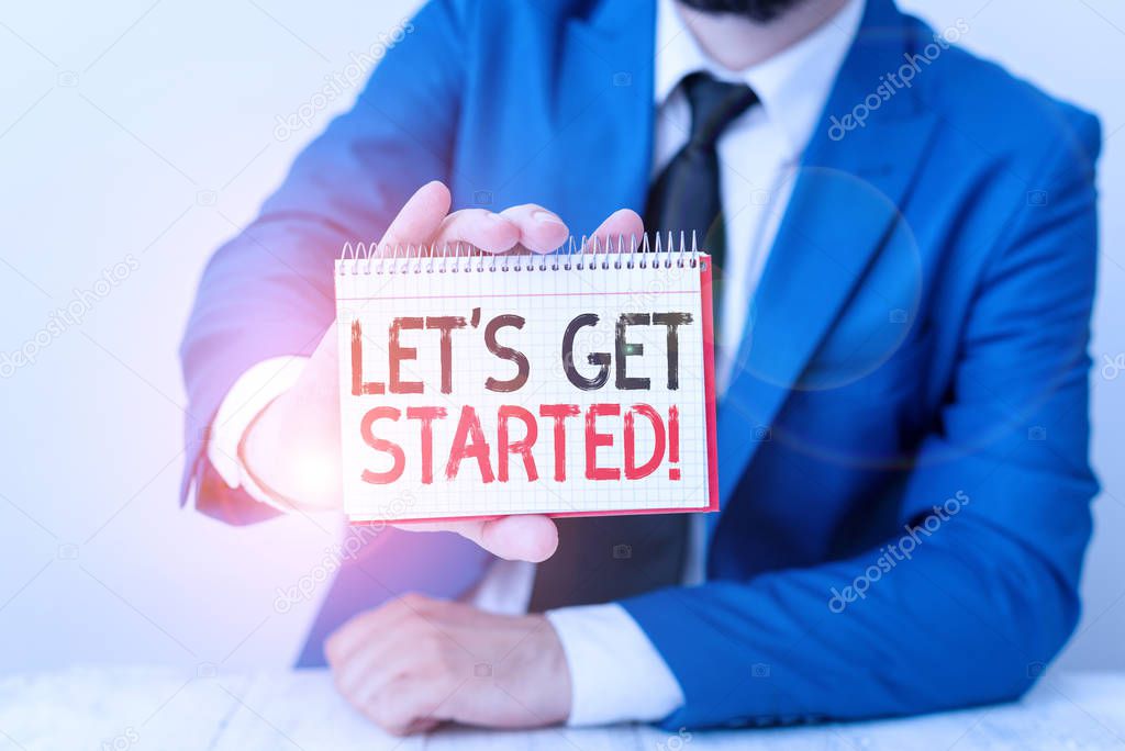 Conceptual hand writing showing Let S Get Started. Business photo showcasing encouraging someone to begin doing something Man holds empty paper with copy space in front of him Space.