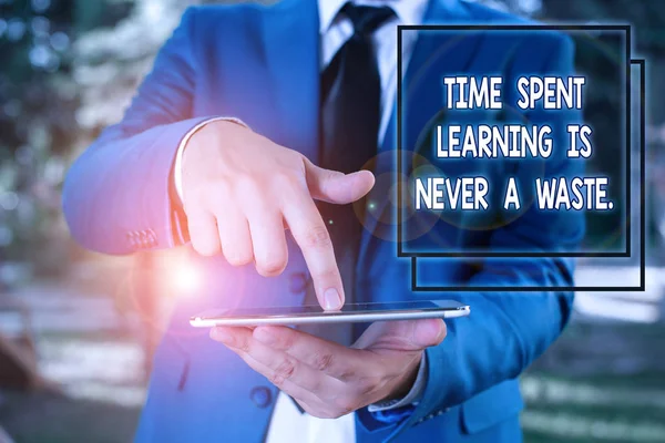 Conceptual hand writing showing Time Spent Learning Is Never A Waste. Business photo text education has no end Keep learning Businessman in blue suite with a tie holds lap top in hands.