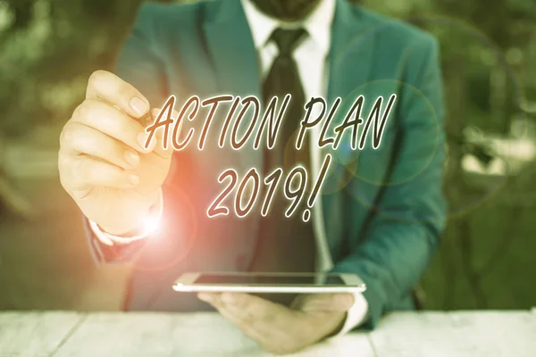 Word writing text Action Plan 2019. Business concept for proposed strategy or course of actions for current year Businessman pointing with pen in empty copy space.