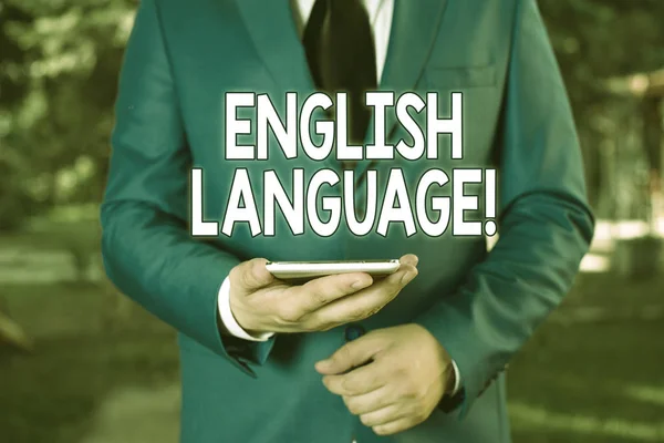 Conceptual hand writing showing English Language. Business photo text third spoken native lang in world after Chinese and Spanish Businessman in blue suite stands with mobile phone in hands. — Stock Photo, Image