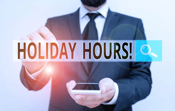 Text sign showing Holiday Hours. Conceptual photo Overtime work on for employees under flexible work schedules Male human wear formal work suit hold smart hi tech smartphone use one hand. — Stock Photo, Image