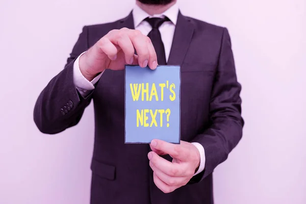 Word writing text What S Next Question. Business concept for asking demonstrating about his coming actions or behaviors Male human wear formal work suit office look hold notepaper sheet use hand. — Stockfoto