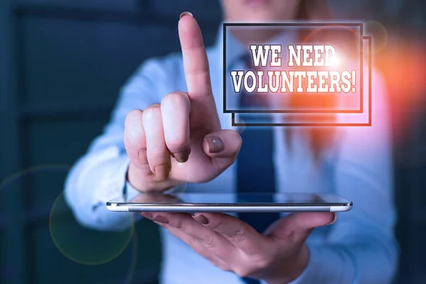 Word writing text We Need Volunteers. Business concept for someone who does work without being paid for it Blurred woman in the background pointing with finger in empty space. — Stock Photo, Image