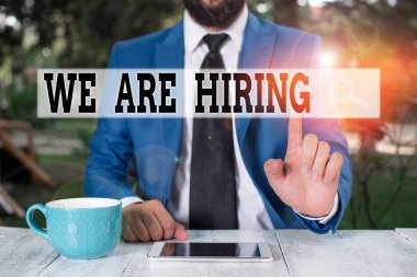 Text sign showing We Are Hiring. Conceptual photo Workforce Wanted HR recruiting new hire employee Vacancy Businessman with pointing finger in front of him.