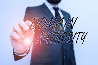 Writing note showing Domain Authority. Business photo showcasing calculated metric for how well a domain is likely to rank Male human with beard wear formal working suit clothes hand. clipart