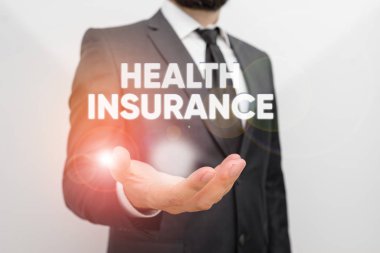 Conceptual hand writing showing Health Insurance. Business photo text reimburse the insured for expenses incurred from illness Male human with beard wear formal working suit clothes hand.
