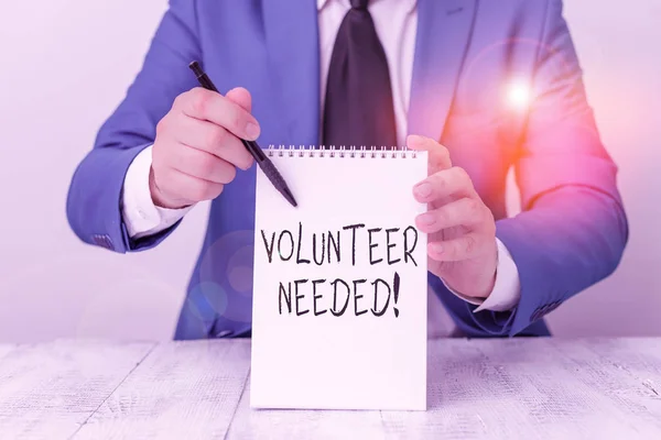 Handwriting text Volunteer Needed. Concept meaning need work for organization without being paid Man holds empty paper with copy space in front of him Copy Space.