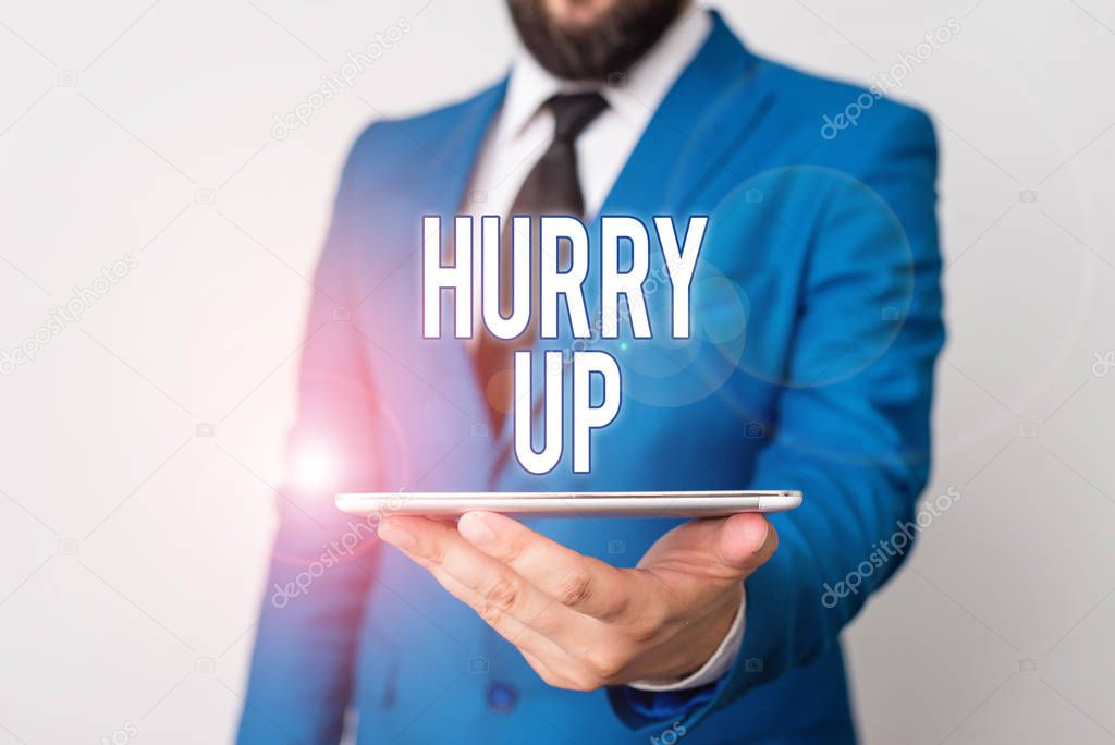 Conceptual hand writing showing Hurry Up. Business photo text asking someone to do a job very fast Quickly Lets go Encourage Businessman in blue suite with a tie holds lap top in hands.
