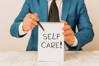Handwriting text Self Care. Concept meaning practice of taking action preserve or improve ones own health Man holds empty paper with copy space in front of him Copy Space. clipart