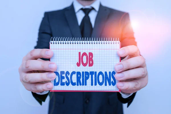 Writing note showing Job Descriptions. Business photo showcasing a formal account of an employee s is responsibilities Male human wear formal work suit with office look hold book. — Stock Photo, Image