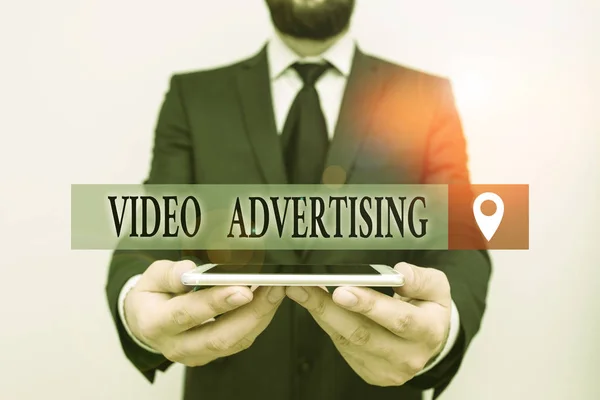 Conceptual hand writing showing Video Advertising. Business photo text encompasses online display advertisements that have video Male human wear formal work suit hold smartphone using hand. — Stock Photo, Image
