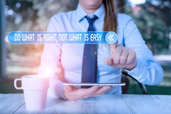 Handwriting text writing Do What Is Right Not What Is Easy. Concept meaning willing to stand up for what is right Female business person sitting by table and holding mobile phone.