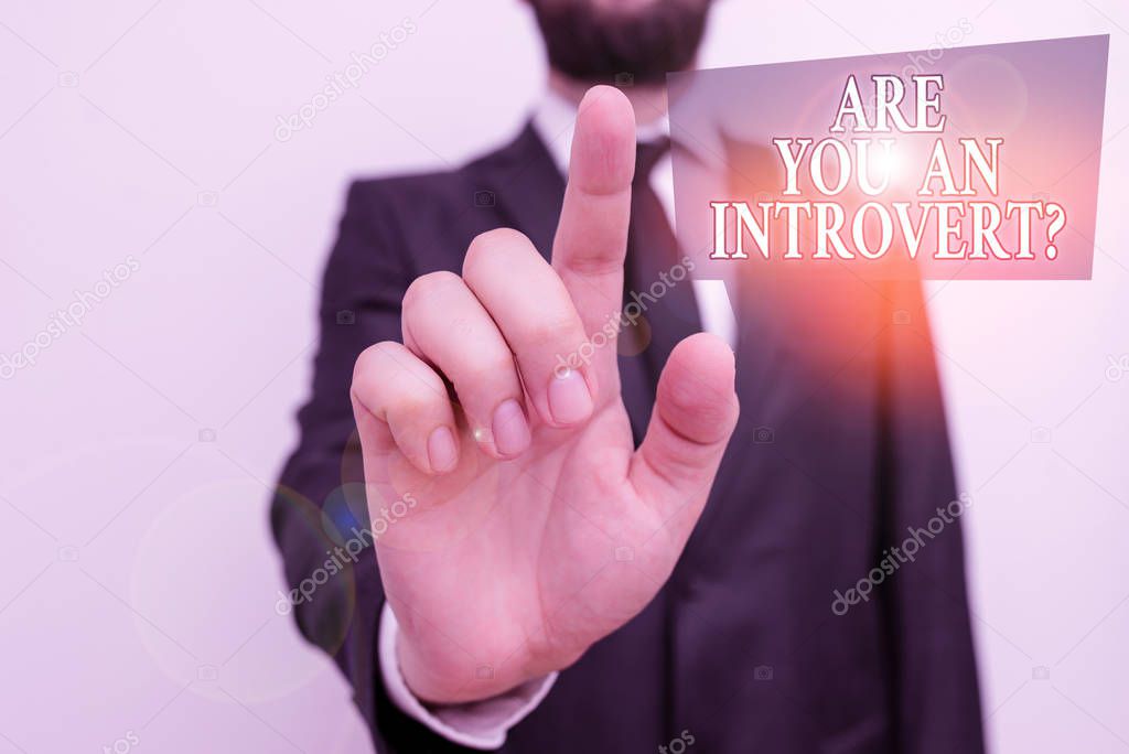 Conceptual hand writing showing Are You An Introvertquestion. Business photo showcasing demonstrating who tends to turn inward mentally Male human with beard wear formal working suit clothes hand.