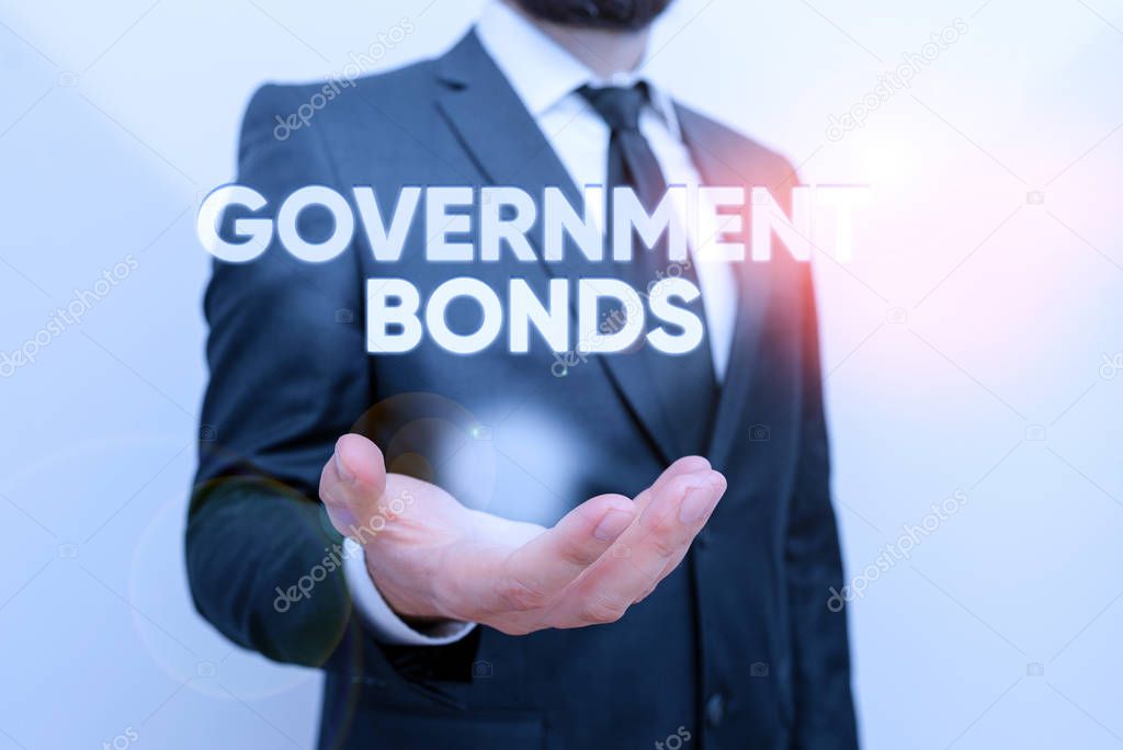Conceptual hand writing showing Government Bonds. Business photo text debt security issued by a government to support spending Male human with beard wear formal working suit clothes hand.