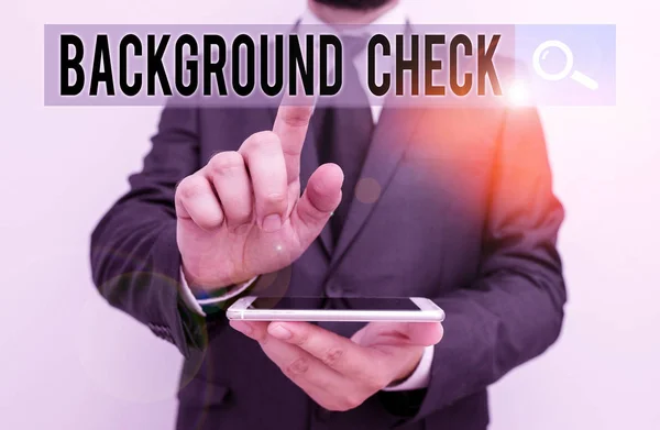 Writing note showing Background Check. Business photo showcasing investigation into a demonstrating s is origins and previous history Male human wear formal work suit hold smartphone using hand. — Stock Photo, Image