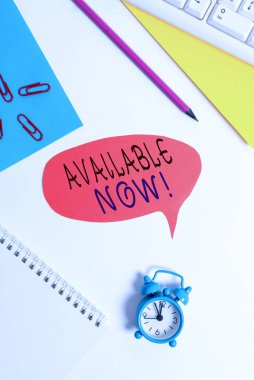 Şu anda müsait olduğunu gösteren bir not yazılıyor. İş fotoğrafı gösterimi şu anda elde edilebilir ya da kullanılabilir durumda. Kırmızı baloncuklu fotokopi kağıdı saat ile masada..