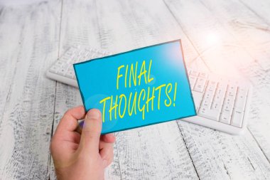 Writing note showing Final Thoughts. Business photo showcasing should be last few sentences within your conclusions Man holding colorful reminder square shaped paper wood floor. clipart