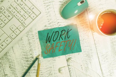 El yazısı, İş Güvenliği. Kavram, çalışanların sağlığını sağlamak için uygulanan politikalar ve prosedürler anlamına geliyor. Teknolojik cihazlar Renkli hatırlatıcı kağıt ofis klavye faresi tedarik.