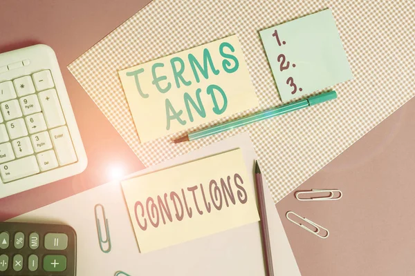 Text sign showing Terms And Conditions. Conceptual photo rules that apply to fulfilling a particular contract Writing equipments and computer stuffs placed above colored plain table.