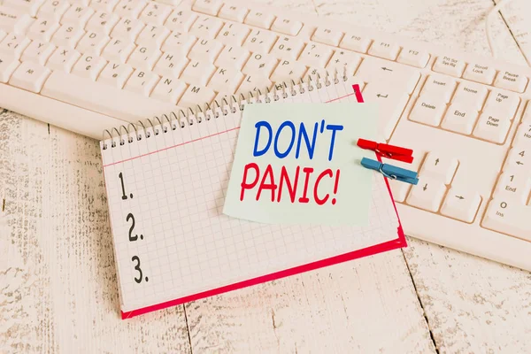 Handwriting text Don T Panic. Concept meaning suddenly feel so worried or frightened that you can not behave notebook paper reminder clothespin pinned sheet white keyboard light wooden. — 스톡 사진