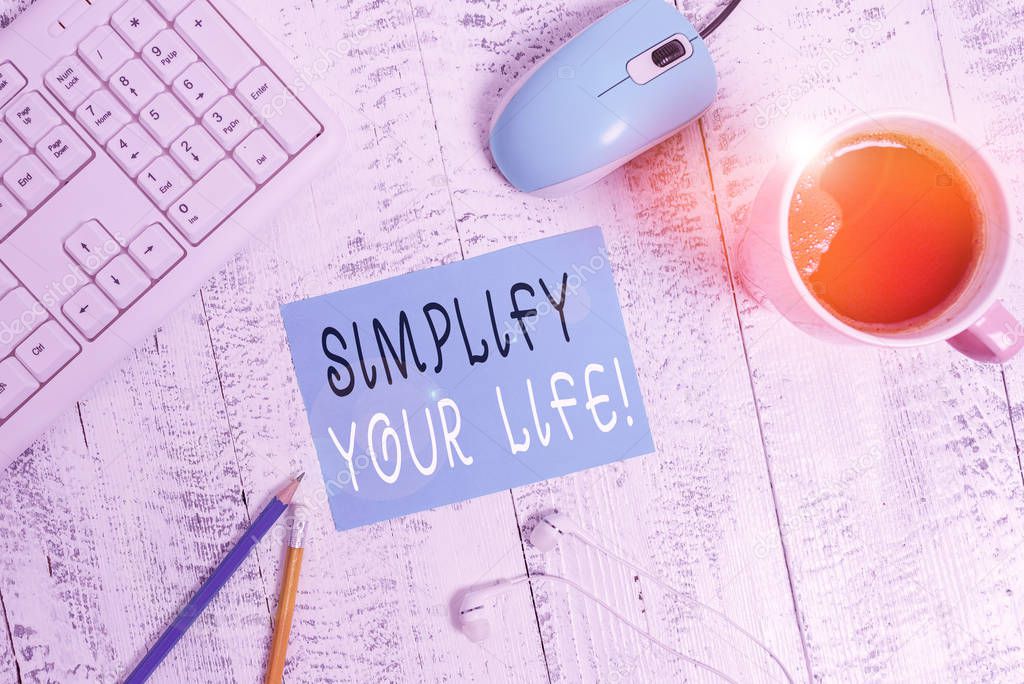 Word writing text Simplify Your Life. Business concept for focused on important and let someone else worry about less ones technological devices colored reminder paper office supplies keyboard mouse.