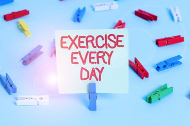 Word writing text Exercise Every Day. Business concept for move body energetically in order to get fit and healthy Colored clothespin papers empty reminder blue floor background office pin.