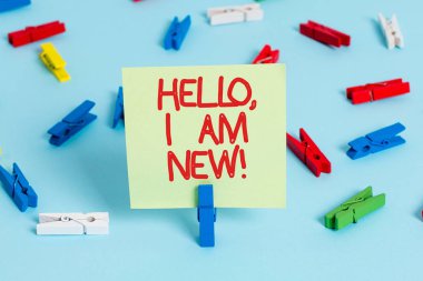 Kelime yazma metni Merhaba Ben yeniyim. Bir gruba kendini yeni işçi ya da öğrenci olarak tanıtma konsepti. Renkli çamaşır iğnesi kağıtları. Boş hatırlatma mavi zemin ofis rozeti..