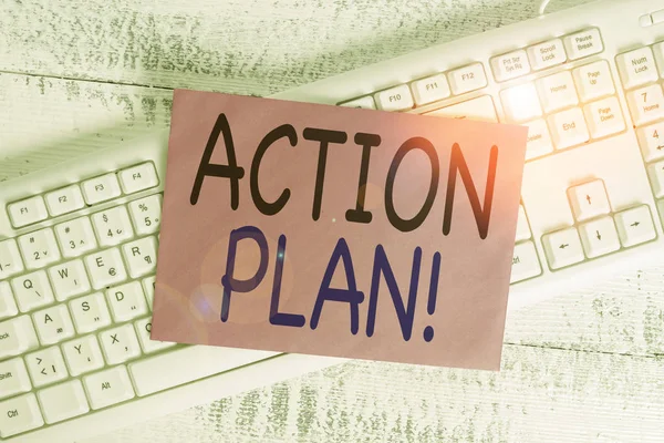 Word writing text action plan. Geschäftskonzept für vorgeschlagene Strategie oder Vorgehensweise für bestimmte Zeit weiße Tastatur Büro liefert leere rechteckige Papier Erinnerung Holz. — Stockfoto