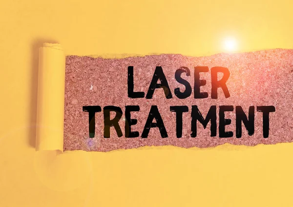 Word writing text Laser Treatment. Business concept for any of various medical and surgical techniques using lasers Cardboard which is torn in the middle placed above a wooden classic table. — 图库照片