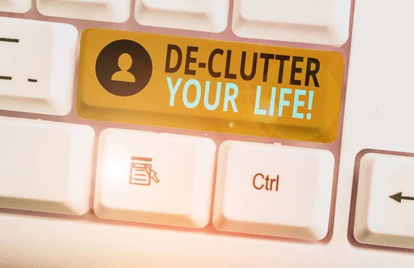 De Clutter Your Lifeを示すメモを書く。雑然としない場所や混雑しない場所から不要なアイテムを削除するビジネス写真. — ストック写真