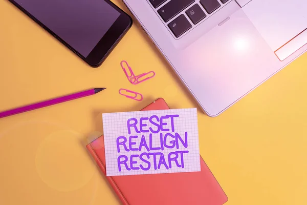 Conceptual hand writing showing Reset Realign Restart. Business photo showcasing Life audit will help you put things in perspectives Laptop smartphone clip pencil paper sheet colored background. — Stock Photo, Image