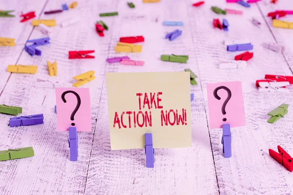 Writing note showing Take Action Now. Business photo showcasing do something official or concerted achieve aim with problem Crumbling sheet with paper clips placed on the wooden table.