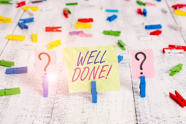 Word writing text Well Done. Business concept for used praising demonstrating or group for something have done good way Scribbled and crumbling sheet with paper clips placed on the wooden table.