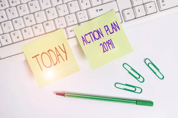 Word writing text action plan 2019. business concept for proposed strategy or course of actions for current year square green note paper with pencil on the white background. — Stockfoto
