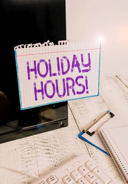 Conceptual hand writing showing Holiday Hours. Business photo text Overtime work on for employees under flexible work schedules Note paper taped to black screen near keyboard stationary. — Stock Photo, Image