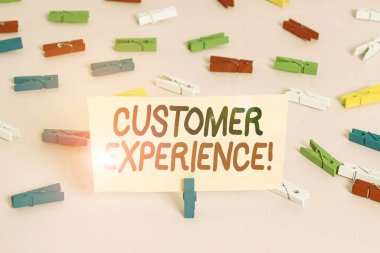 Conceptual hand writing showing Customer Experience. Business photo showcasing product of interaction between organization and buyer Colored clothespin papers empty reminder pink floor office.