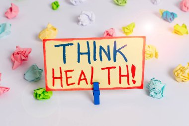 Handwriting text Think Health. Concept meaning state of complete physical mental and social well being Colored crumpled papers empty reminder white floor background clothespin.