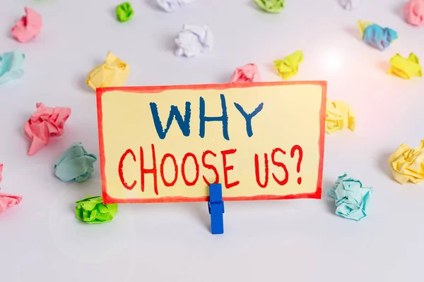 Handwriting text Why Choose Us Question. Concept meaning list of advantages and disadvantages to select product service Colored crumpled papers empty reminder white floor background clothespin.