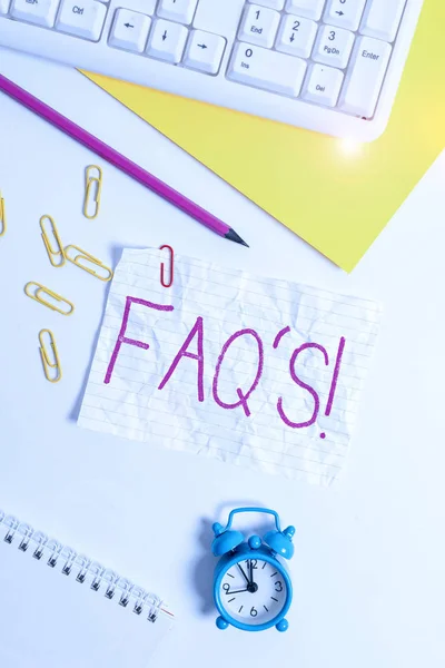 Handwriting text writing Faq S. Concept meaning list of questions and answers relating to particular subject Flat lay above white blank paper with copy space for text messages. — Stok fotoğraf