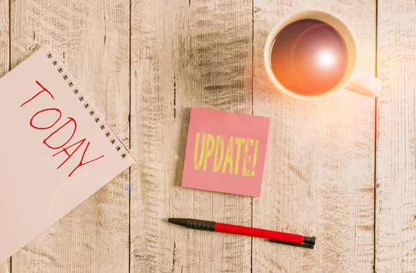 Writing note showing Update. Business photo showcasing make something more modern or up to date like software program Stationary placed next to a cup of black coffee above the wooden table. — Stock Photo, Image
