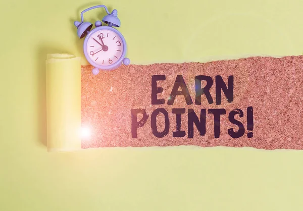 Conceptual hand writing showing Earn Points. Business photo text collecting scores in order qualify to win big prize Alarm clock and torn cardboard on a wooden classic table backdrop.
