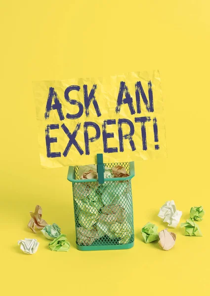 Conceptual hand writing showing Ask An Expert. Business photo text confirmation that have read understand and agree with guidelines Trash bin crumpled paper clothespin office supplies yellow.