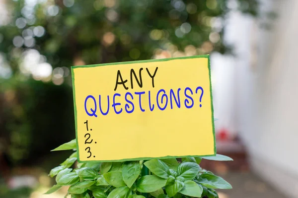 Writing note showing Any Questions Question. Business photo showcasing you say write order to ask demonstrating about something Plain paper attached to stick and placed in the grassy land.