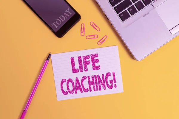 Woord schrijven tekst Life Coaching. Zakelijk concept voor het demonstreren gebruikt om te helpen tonen bereiken van hun doelen in carrière Trendy open laptop smartphone marker papier vel clips gekleurde achtergrond. — Stockfoto