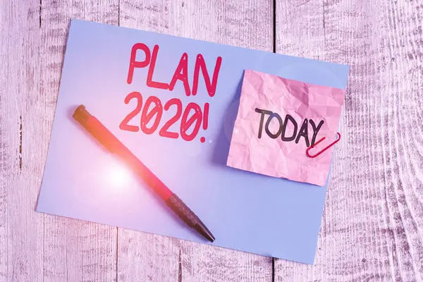 Text sign showing Plan 2020. Conceptual photo detailed proposal doing achieving something next year Wrinkle paper and cardboard plus stationary placed above wooden background. — Stock Photo, Image